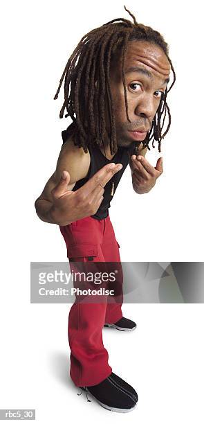 an african american male with dreadlocks wearing red excercise pants and a black tank top looks at the camera and gestures to come here - ehre stock pictures, royalty-free photos & images