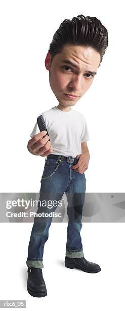 photo caricature of a 50s era greaser in jeans and a t-shirt as he prepares to comb his hair - greaser stock-fotos und bilder
