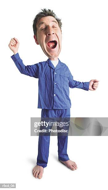 photo caricature of an adult caucasian male in his blue pajamas as he yawns and stretches before bed - giant night of comedy stock-fotos und bilder