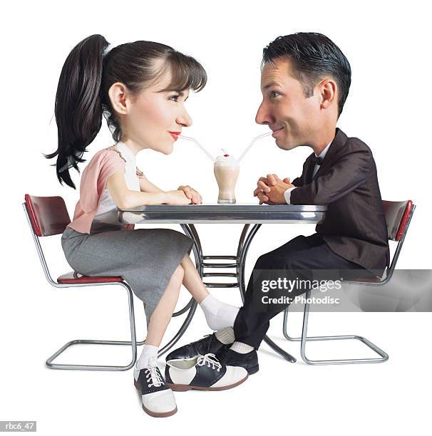 caricature of caucasian 50s era young couple as they share a soda and play footsies at a malt shop - playing footsie stock pictures, royalty-free photos & images