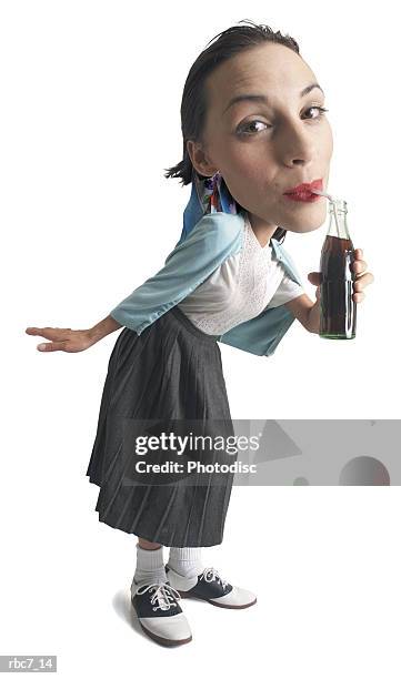 photo caricature of a young girl dressed in 50s retro clothes leans in drinks from a soda bottle - big head bildbanksfoton och bilder