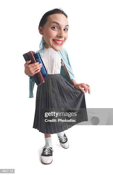 photo caricature of a young girl dressed in 1950s retro clothes poses as a school girl - levenslang leren stockfoto's en -beelden