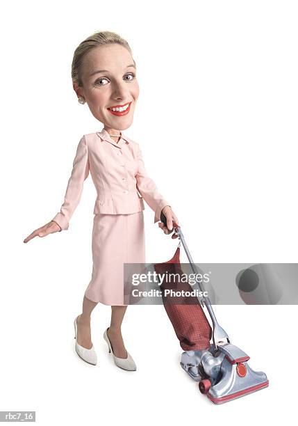 photo caricature of a caucasian woman dressed as a retro 1950 housewife as she vacuums - huge task stock pictures, royalty-free photos & images