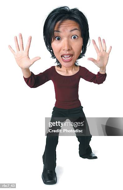 photo caricature of an asian woman in black pants and a maroon shirt throws up her arms as if to say stop - maroon - fotografias e filmes do acervo