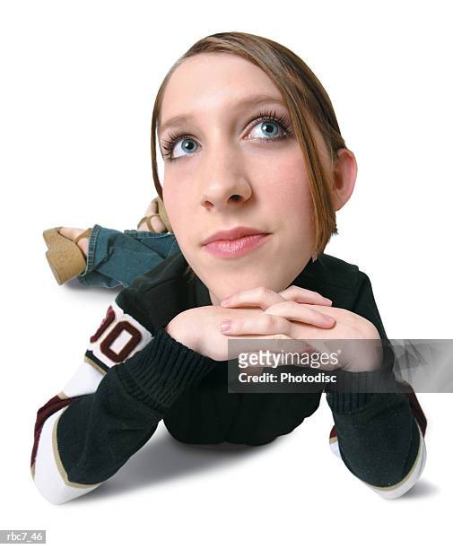 photo caricature of a caucasian teenage girl in black high school sweater as she lays down and looks off to the side as if bored - body lying down stock pictures, royalty-free photos & images