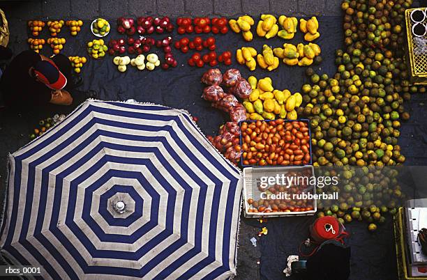 meduim shot of an outside stand covered with colorful fruits and vegetables - garden umbrella stock pictures, royalty-free photos & images