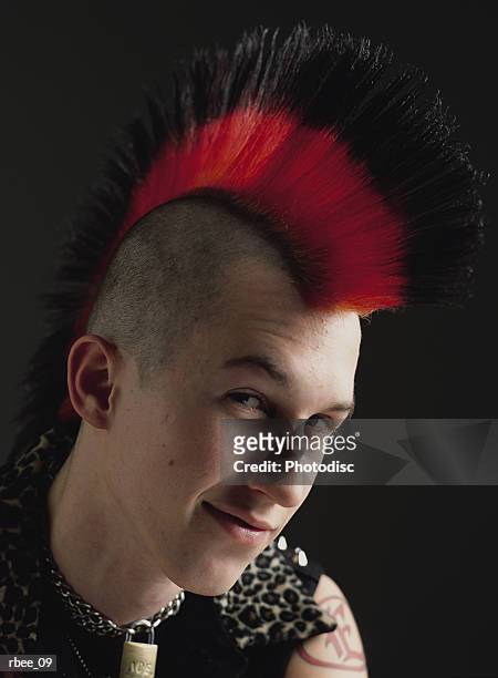 A Male Caucasian Teenager With A Red And Black Mohawk Is Dressed In Punk  Clothes And Smirking High-Res Stock Photo - Getty Images