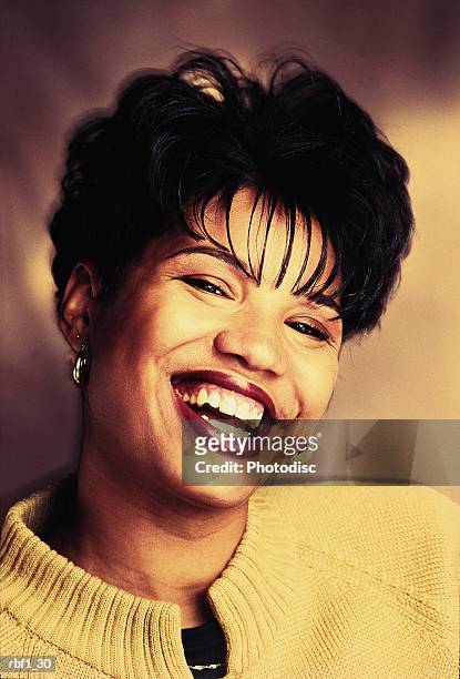 happy woman female with short black hair and red lipstick wearing a yellow sweater laughs and smiles with beautiful teeth and closes her eyes - happy stockfoto's en -beelden