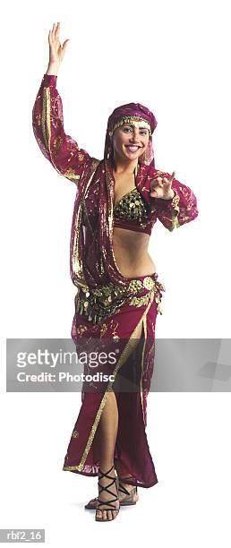 an adult female in a traditional outfit performs a belly dance - belly dancer stock pictures, royalty-free photos & images