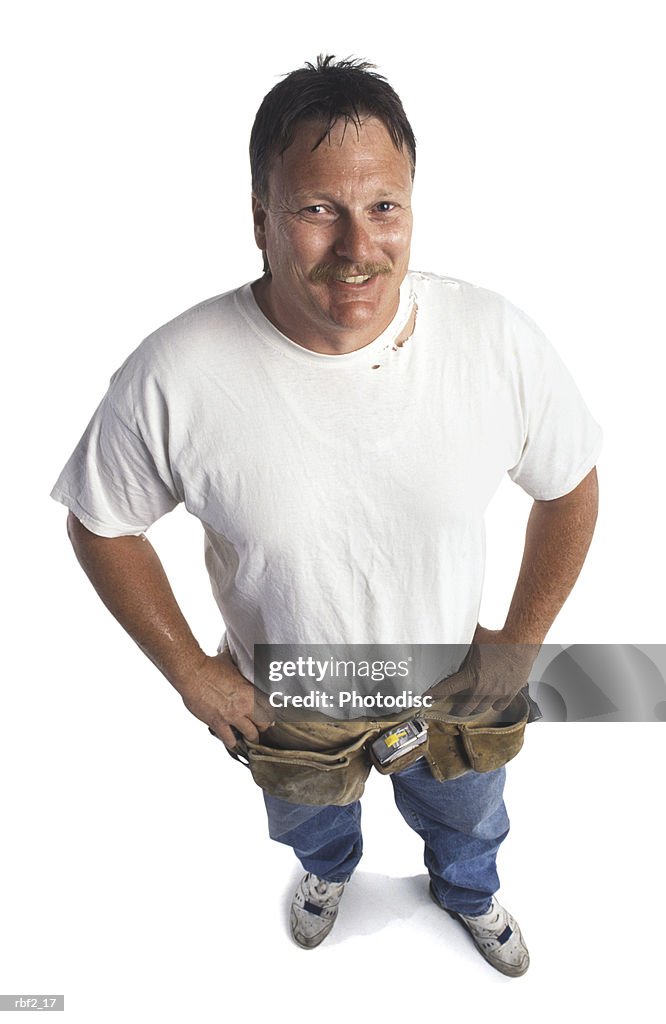 A large adult man in jeans and a white tee shirt smiles up at the camera