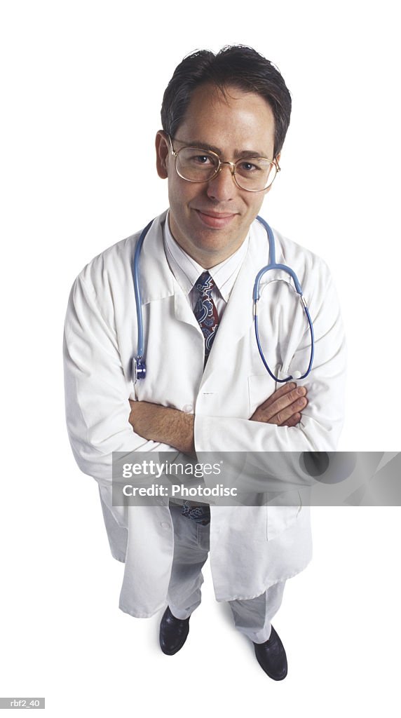 An adult male doctor folds his arms and smiles up at the camera