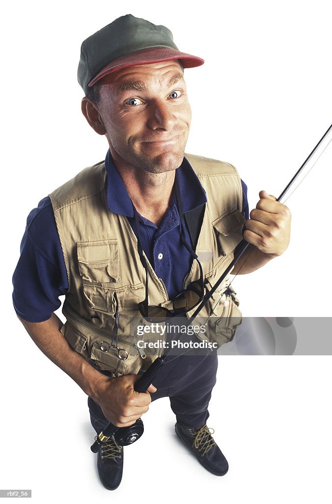 An Adult Male Fisheman In A Vest And His Fishing Pole Smiles Up At