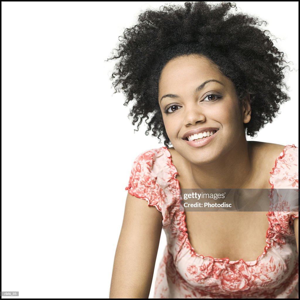 Portrait of a young adult woman in a floral print shirt as she smiles brightly