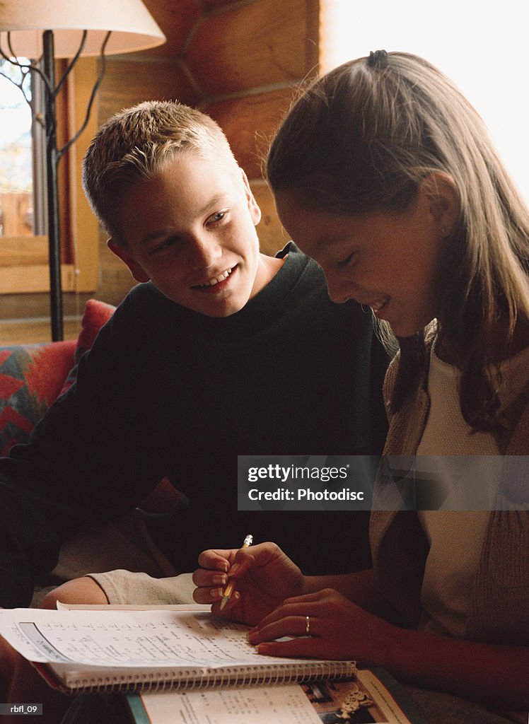 Two teenagers working on a writing assignment together