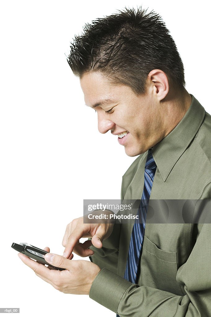 Medium shot of a young adult business man as he uses his electronic planner