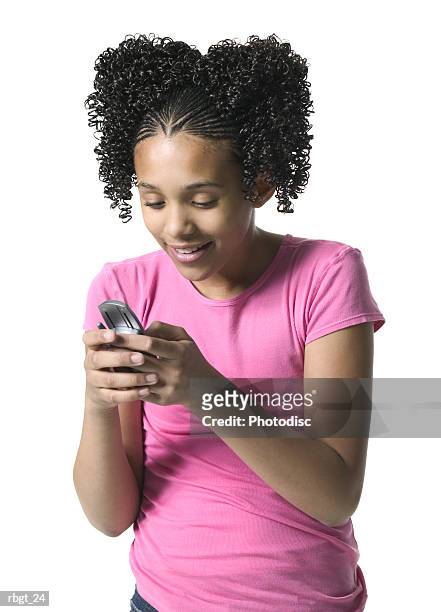 medium shot of a teenage female as she writes a text message on her cell phone - phone message stock pictures, royalty-free photos & images