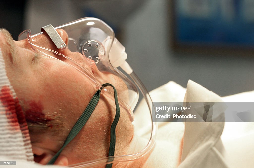Close up of caucasain male patient with a head trauma and an oxygen mask