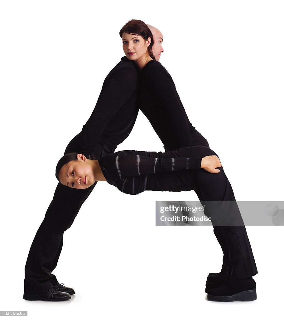 Three young adults dressed in black form the letter A