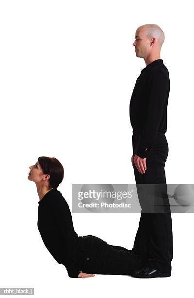 two young adults dressed in black create the letter j - j j stock pictures, royalty-free photos & images