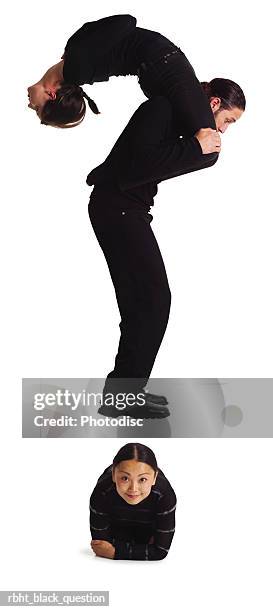 three young adults dressed in black create a question mark - punctuation mark stockfoto's en -beelden