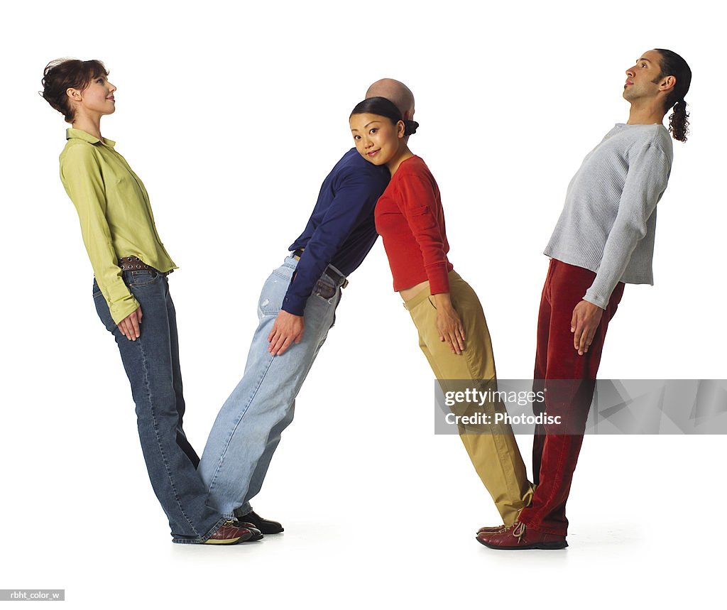 Four young adults in colorful clothes create the letter W