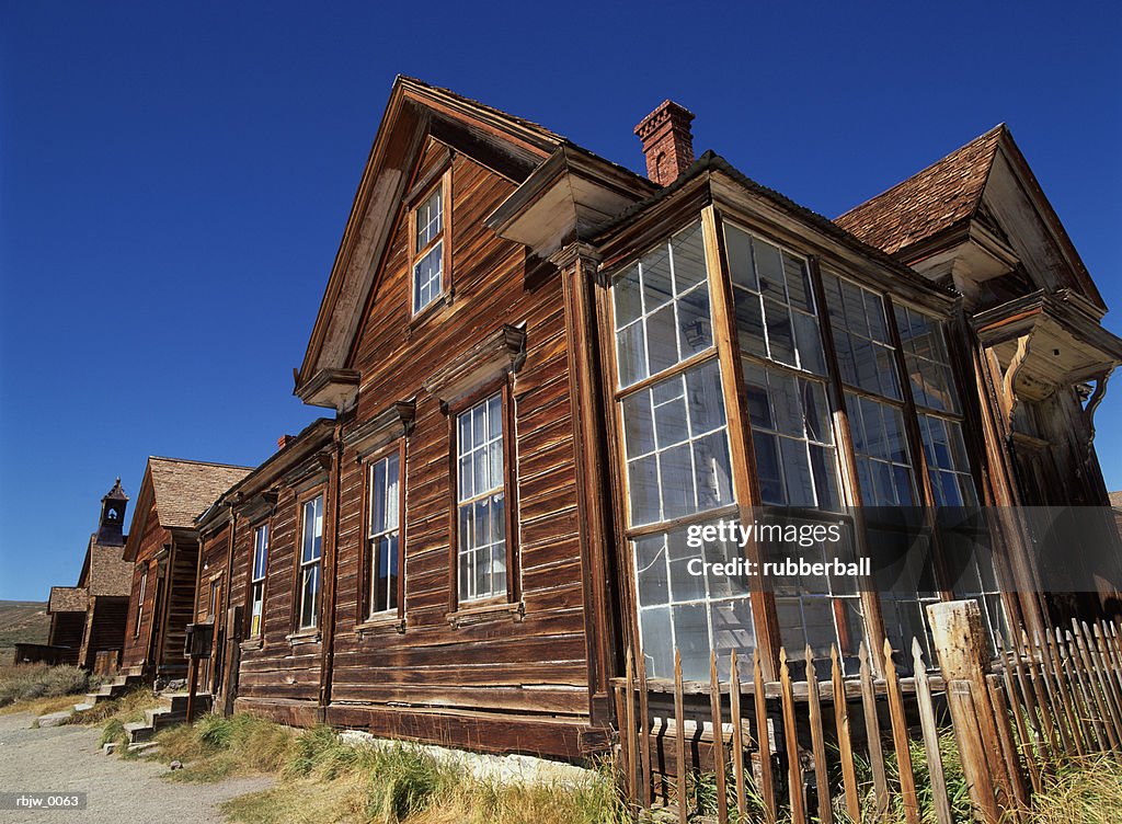 Old wooden buildings in the ghost town of bodie california are seen in the noon sun