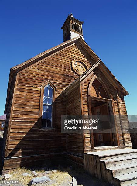 a close up of the front of an old wooden church in the desert ghost town of bodie california - town imagens e fotografias de stock