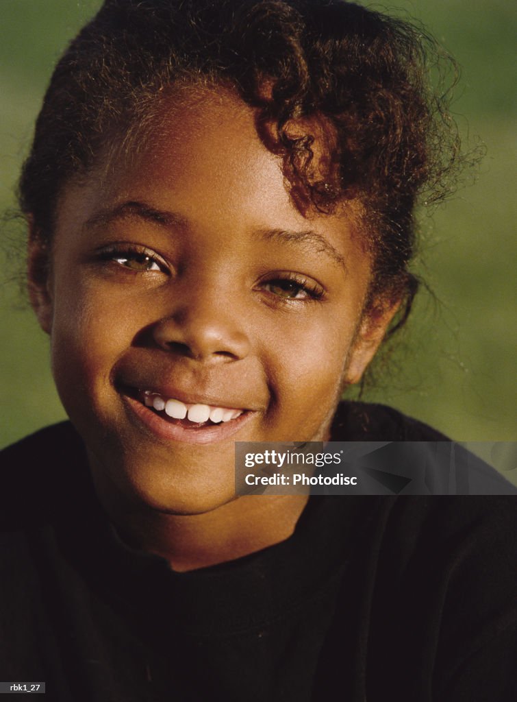 An african american young girl gives a sincere smile