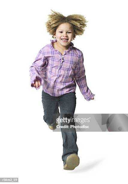 full body shot of a curly haired female child as she runs forward and jumps - curly stock pictures, royalty-free photos & images