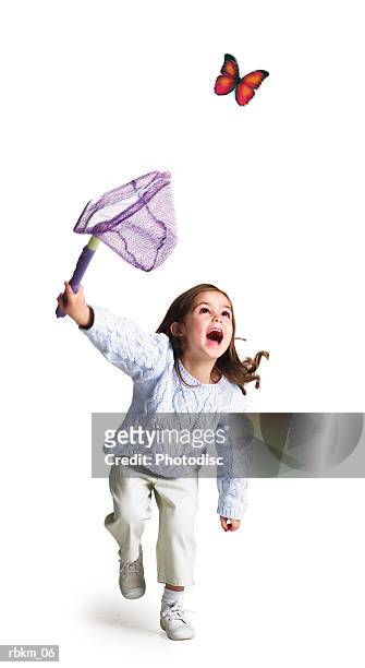 a little caucasian girl runs with a net trying to catch a butterfly - butterfly net stock-fotos und bilder