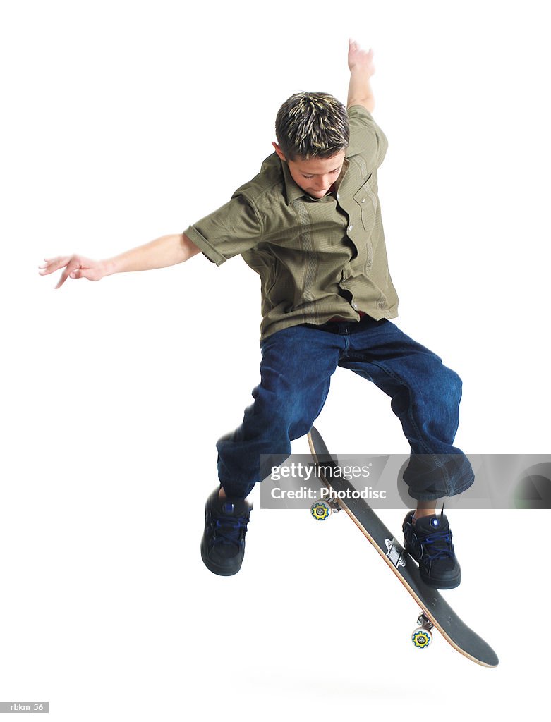 A young caucasian boy does tricks on his skateboard