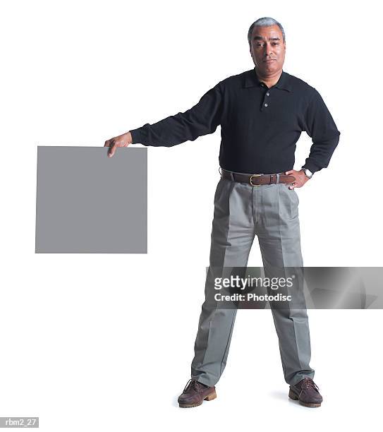an elderly african american male in grey pants and a black shirt hold a square signs out to his side - grey shirt stock pictures, royalty-free photos & images