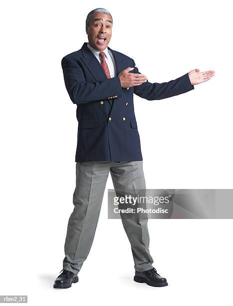 an elderly african american male in a jacket and tie gestures enthusiastically to his side - male portrait suit and tie stock-fotos und bilder