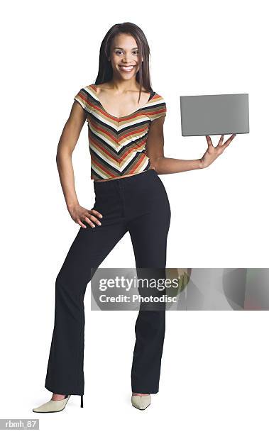 a young attractive african american girl in black pants and striped blouse holds a blank sign or box to the side of her with one hand - or stock pictures, royalty-free photos & images