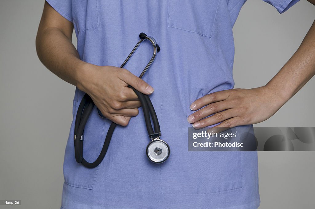 A female medical professional holds her stethoscope in her hands