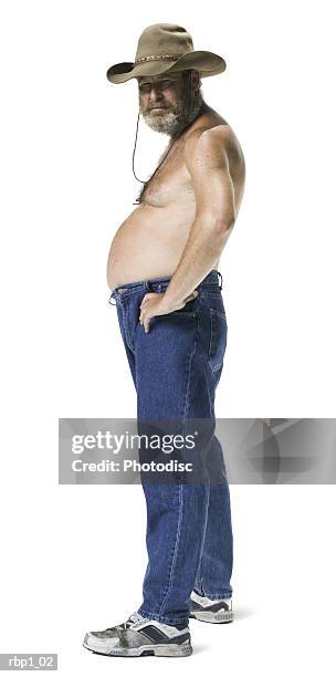 full length shot of a shirtless adult male in a cowboy hat as he turns and smiles - man full body isolated stock pictures, royalty-free photos & images