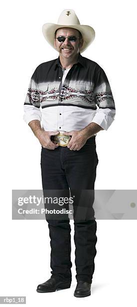 full length shot of an adult male in a cowboy hat and shirt as he smiles brightly at the camera - handlebar moustache stock pictures, royalty-free photos & images