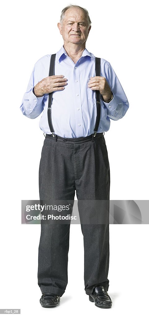 Full length shot of a senior adult male in a blue shirt and suspenders as he smiles