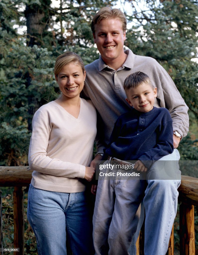An outdoor portrait of a small caucasian family