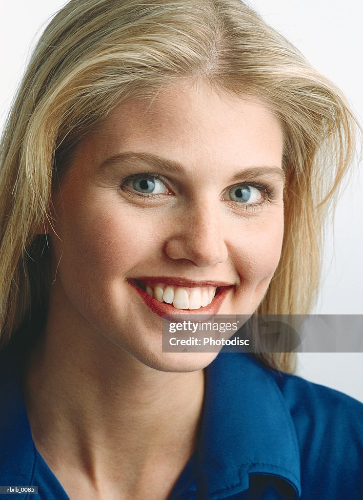 A sweet blonde caucasian girl smiles