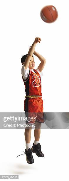 child african american male basketball player in a red uniform and untied shoe jumps and shoots - untied stock pictures, royalty-free photos & images