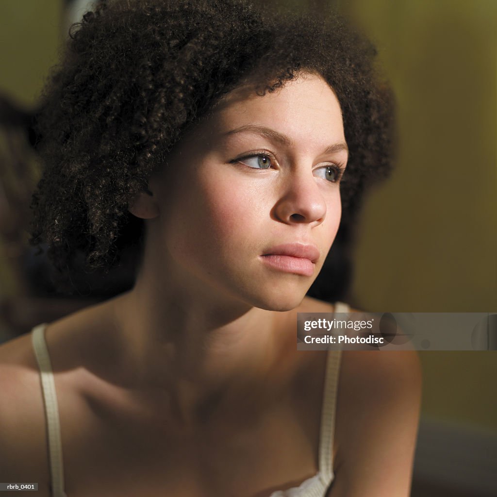 Lifestyle portrait of an attractive young african american woman in a white tank top