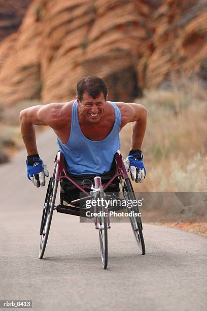 lifestyle photograph of a caucasian male wheelchair racer as he trains in a red rock canyon - red canyon bildbanksfoton och bilder