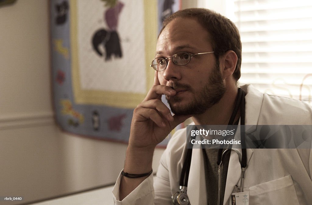 Lifestyle portrait of a bearded caucasian male doctor as he ponders something