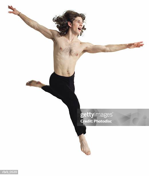 a young caucasian male dancer in black pants and no shirt as he jumps up and dances - no fotografías e imágenes de stock