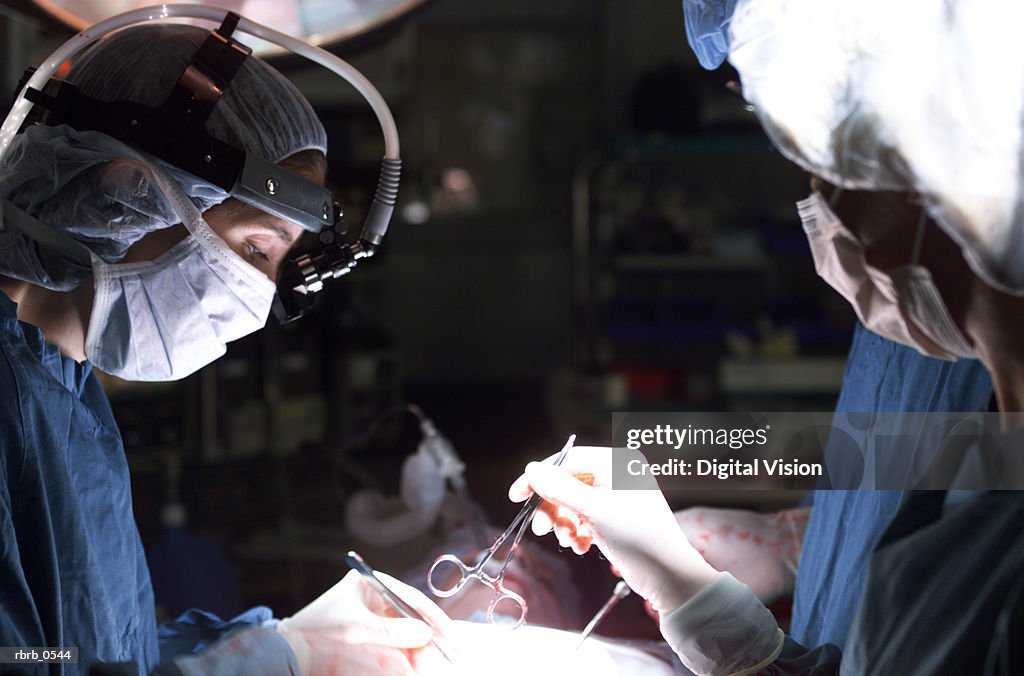 A team of doctors operate on a patient