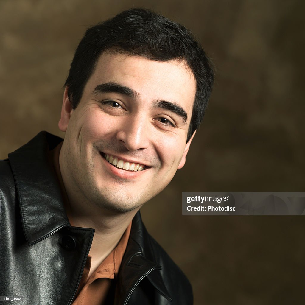 Portrait of an adult ethnic man in a leather jacket as he smiles brightly