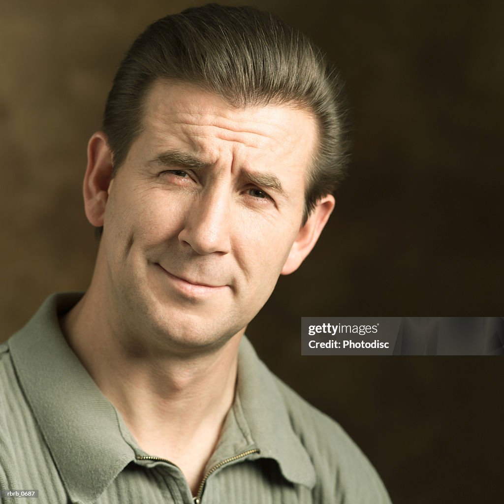 Portrait of an adult caucasian man as he grimaces into the camera