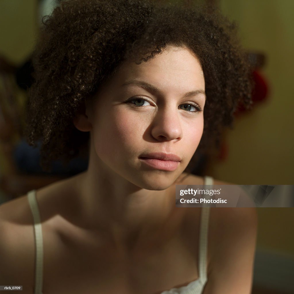 Portrait of an african american teenage girl with as she looks seriously into the camera