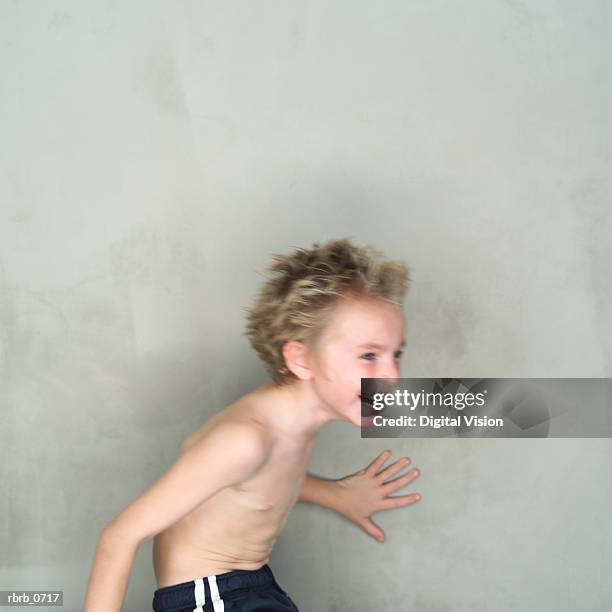 portrait of a caucasian male child with no shirt as he spins and laughs - no fotografías e imágenes de stock